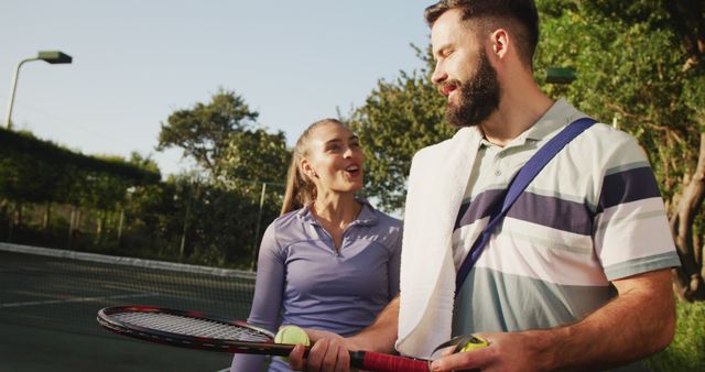 Happy Couple Engaging in Tennis on Outdoor Court - Download Free Stock Images Pikwizard.com