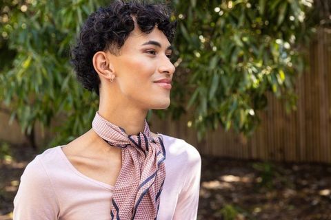 Stylish Young Man in Pink Attire Relaxed Outdoors