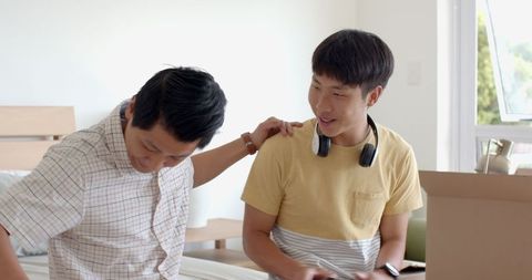 Father congratulates son with surprise car key gift at home