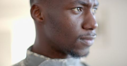 Thoughtful Soldier Gazing into Distance Indoors