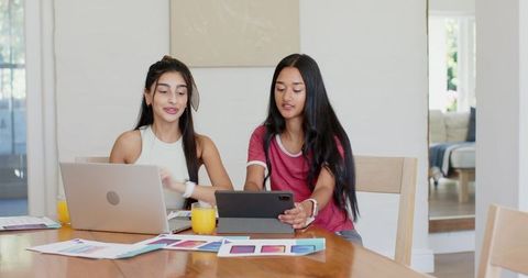 Creative Young Women Collaborating on Design Project at Home