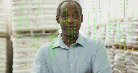Warehouse manager wearing blue shirt overlaid with binary data stream for smart logistics