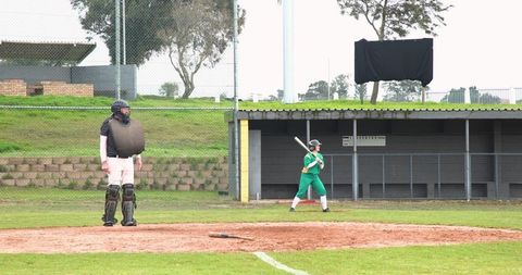 Female softball batter facing catcher on field