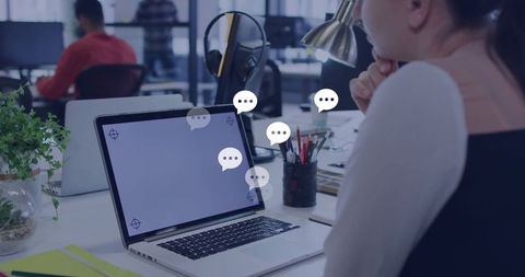 Businesswoman engaged in digital messaging in modern office space