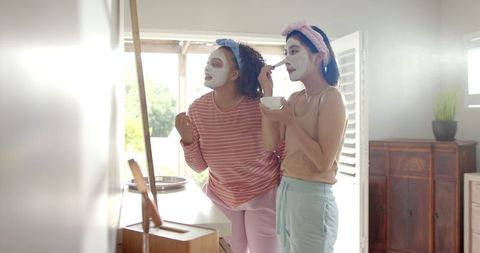 Diverse friends enjoying skincare routine together