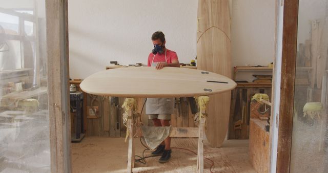 Caucasian Surfboard Maker Buffing Wooden Board in Workshop - Download Free Stock Images Pikwizard.com