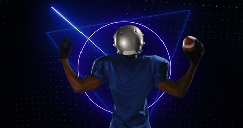 A male American football player standing with his back to the viewer, holding a ball under vibrant digital neon graphics suggestive of modern technology. Ideal for illustrating the merging of sports with digital innovation, use in technology-themed sports promotions, or capturing fictional futuristic sports concepts.