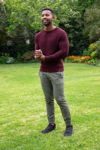 Man Relaxing on Green Lawn in Lush Garden Setting