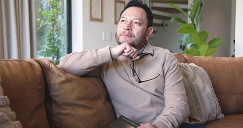 Mature Man Deep in Thought While Reflecting at Home