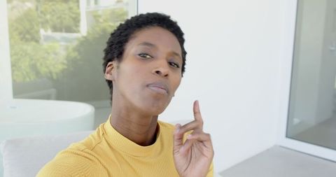 Contemplative Woman Relaxing Outside Modern Home
