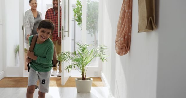 Family Entering Home with Excited Boy Running - Download Free Stock Images Pikwizard.com