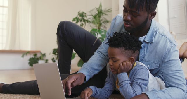 Father and Son Using Laptop at Home in Living Room - Download Free Stock Images Pikwizard.com