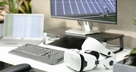 Modern desk with vr headset and solar panel display
