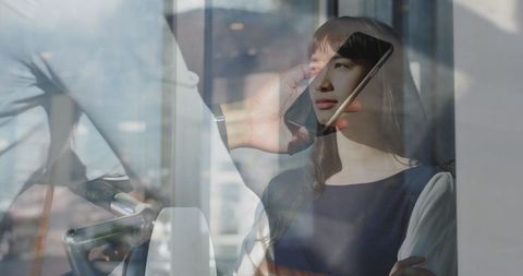 Reflective Businesswoman at Urban Office Window