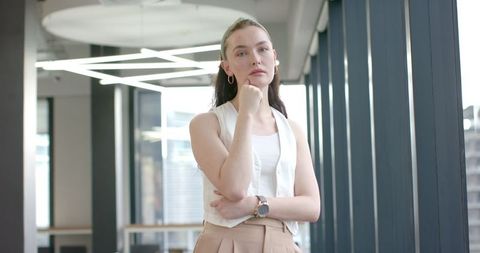 Confident Businesswoman Posing in Contemporary Office with Stylish Attire
