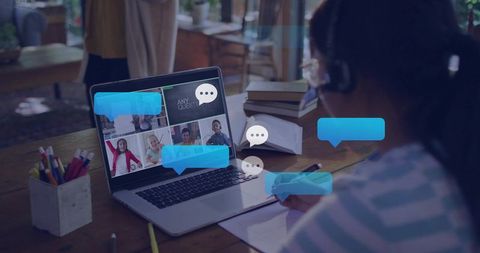 Child Studying Online with Laptop Headphones Notebook Taking Notes in Virtual Classroom