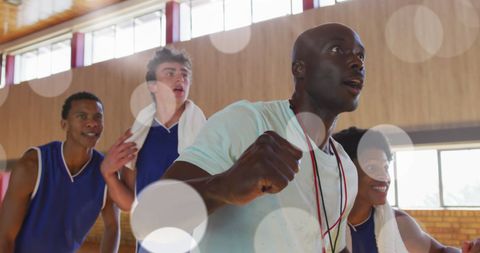 Dedicated Team of Diverse Athletes Training Intently in Gym