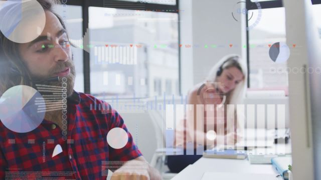 Consultant in casual attire analyzing financial data displayed on screen with various graphs and charts, in a modern office setting. Female colleague working in the background, indicative of teamwork and collaboration. Useful for illustrating office environments, financial analysis, business solutions, and data processing themes.