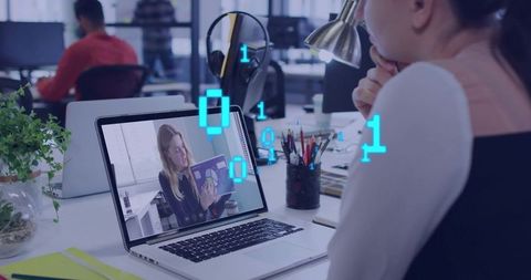 Remote team collaborating on laptop presentation in modern coworking office workspace