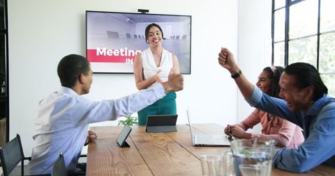 Diverse team celebrating successful meeting with applause