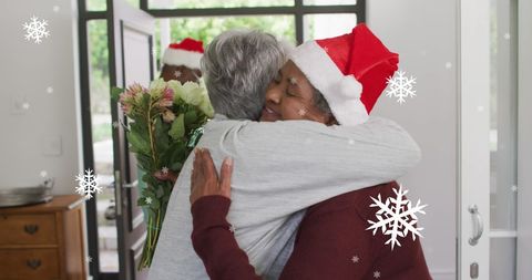 Senior Diverse Friends Hugging with Flowers During Festive Christmas