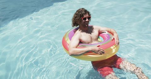 Man Relaxing in Pool on Colorful Float, Embracing Summer Vibes - Download Free Stock Images Pikwizard.com