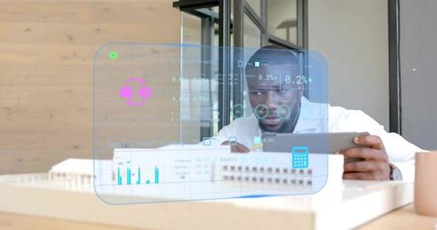 Innovative Analyst Examining Financial Hologram Data on Tablet