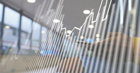 Businesswoman analyzing digital charts on smartphone in office portrait