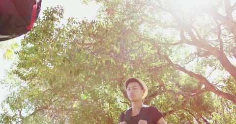 Young Male Hiker Reflecting in Sunlit Forest