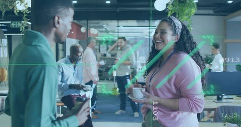 Smiling woman holding coffee chatting with coworker in modern office with green overlay