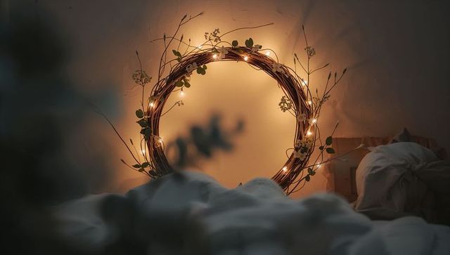 Glowing Twig Wreath Wrapped in Fairy Lights Casting Warm Halo Over Cozy Bedroom