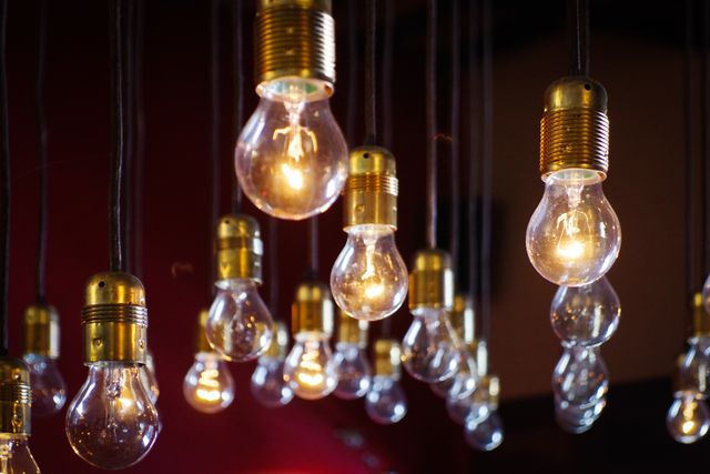 Hanging Light Bulbs With Warm Glow Against Dark Background - Download Free Stock Photos Pikwizard.com