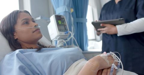 Diverse Female Patient with Doctor in Hospital Ward