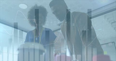 Fashion Designers Analyzing Financial Statistics in Office