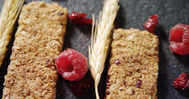 Close-up of granola bars with barley and raspberry on concrete background 4k