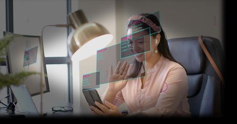 Waving professional woman using smartphone with ar overlays at modern workstation