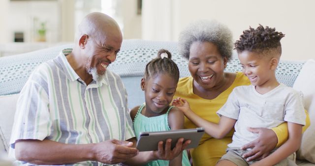 Senior Couple Enjoying Time with Grandchildren on Digital Tablet - Download Free Stock Images Pikwizard.com