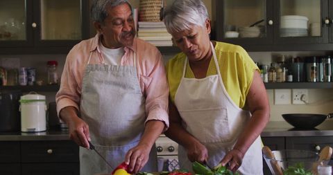 Senior Couple Cooking Together in Home Kitchen