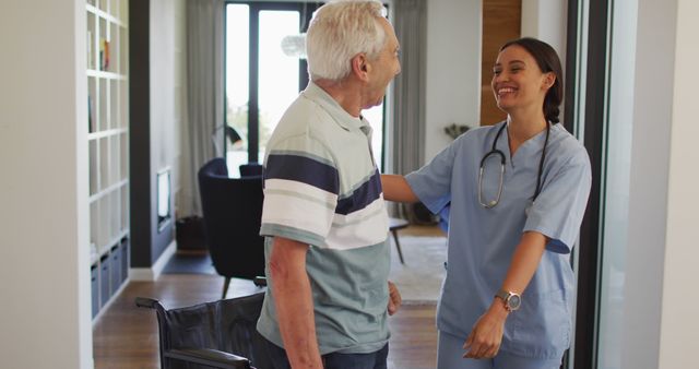 Elderly man transitioning from wheelchair to standing position with smiling caregiver assistance. Ideal use for healthcare services, home care agencies, senior living communities, and medical caregiving advertisements.
