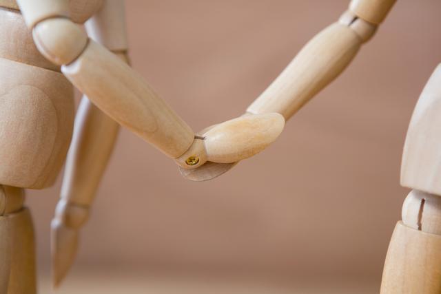 Wooden Mannequins Holding Hands Symbolizing Connection - Download Free Stock Photos Pikwizard.com
