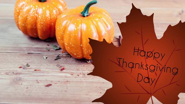 Thanksgiving greeting featuring two pumpkins on rustic wooden board with Happy Thanksgiving text on autumn leaf overlay. Ideal for holiday cards, social media posts, fall event invitations, seasonal marketing materials.