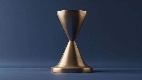 Bronze double-cone sculpture on blue background for modern decor