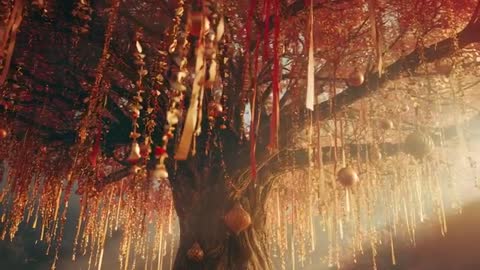 Mystical Tree Adorned with Golden Ribbons and Ornaments Swaying in Breeze