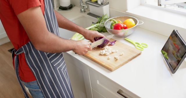 Home Chef Chopping Vegetables in Kitchen Following Recipe on Tablet - Download Free Stock Images Pikwizard.com