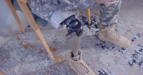 Veteran with Prosthetic Limb in Living Room Setting
