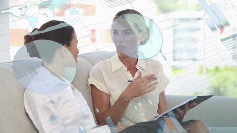 Diverse Businesswomen Analyzing Data in Modern Office Setting