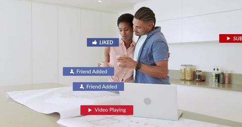 Couple Reviewing Smartphone Notifications Over Blueprints on Modern Kitchen Island