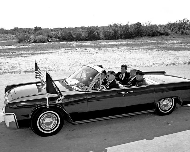 CAPE CANAVERAL Fla. -- Astronaut John H. Glenn Jr. gives a double thumbs-up as he and President John F. Kennedy arrive at the Cape Canaveral Missile Test Annex in Florida. Glenn's Mercury Atlas 6 mission lifted off from Launch Complex 14, in the background, on Feb. 20, 1962. Photo credit: NASA