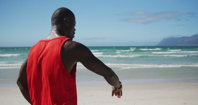 Athletic Man Checking Smartwatch During Beach Workout on Sunny Day - Download Free Stock Images Pikwizard.com