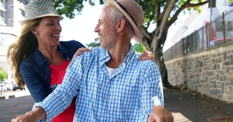 Happy Mature Couple Enjoying Bike Ride Under Sunny Skies